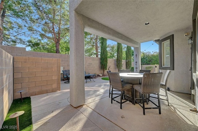 11417 Rock Cove Way, Las Vegas, NV 89141 - fenced backyard with outdoor dining area and a patio