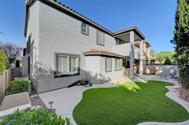 11417 Rock Cove Way, Las Vegas, NV 89141 - back of house with a balcony, stucco siding, a patio area, and a fenced backyard