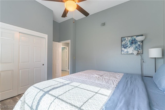 5600 Segolilly Cir, Las Vegas, NV 89130 - bedroom with a closet, vaulted ceiling, light wood-type flooring, and ceiling fan