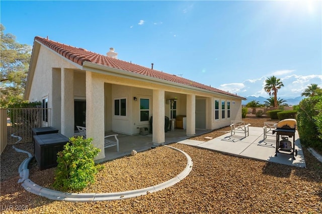 5600 Segolilly Cir, Las Vegas, NV 89130 - back of house featuring stucco siding, a patio area, a chimney, and a tiled roof