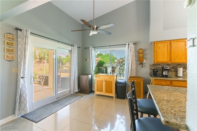 5600 Segolilly Cir, Las Vegas, NV 89130 - entryway featuring high vaulted ceiling, a ceiling fan, and light tile patterned floors