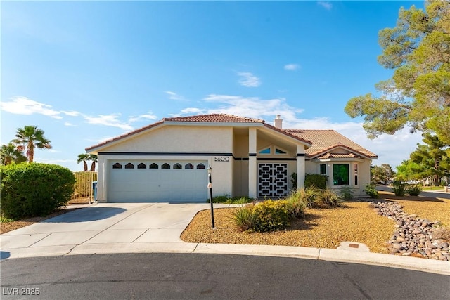 5600 Segolilly Cir, Las Vegas, NV 89130 - mediterranean / spanish home with a tile roof, an attached garage, stucco siding, and concrete driveway