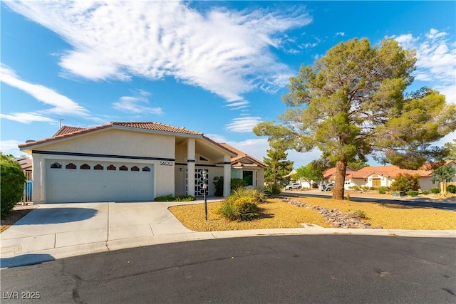 5600 Segolilly Cir, Las Vegas, NV 89130 - view of front of house featuring a tiled roof, concrete driveway, stucco siding, and a garage