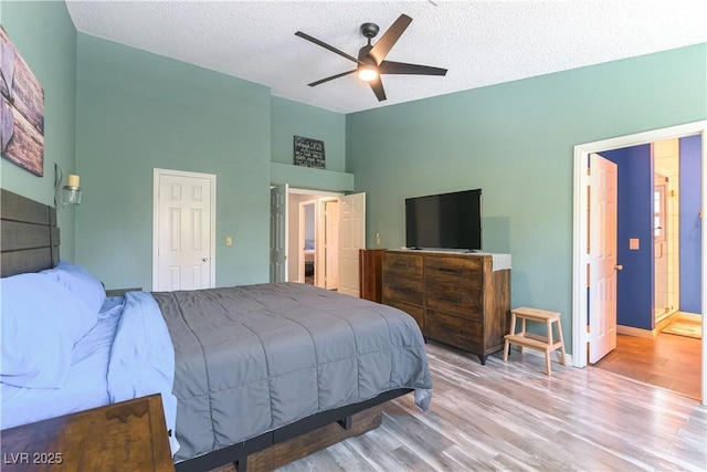 5600 Segolilly Cir, Las Vegas, NV 89130 - bedroom featuring wood finished floors, a textured ceiling, and a ceiling fan