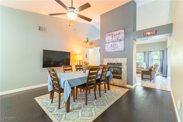 5600 Segolilly Cir, Las Vegas, NV 89130 - dining area featuring wood finished floors, ceiling fan, high vaulted ceiling, and a high end fireplace