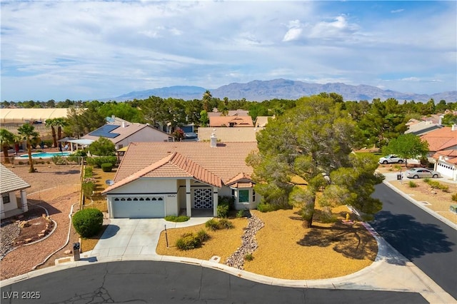 5600 Segolilly Cir, Las Vegas, NV 89130 - view of front of house with driveway, a garage, a mountain view, and stucco siding
