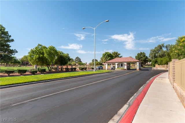 5600 Segolilly Cir, Las Vegas, NV 89130 - view of asphalt road with curbs, street lighting, and sidewalks
