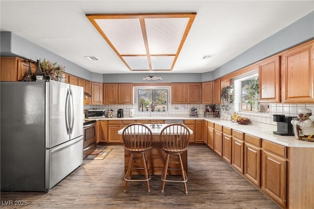 3951 W Blosser Ranch Rd, Pahrump, NV 89060 - kitchen featuring appliances with stainless steel finishes, decorative backsplash, light countertops, and wood finished floors