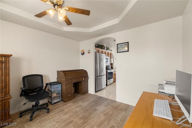 180 W Wilson Rd, Pahrump, NV 89048 - office area featuring arched walkways, a tray ceiling, ceiling fan, and light wood-style floors