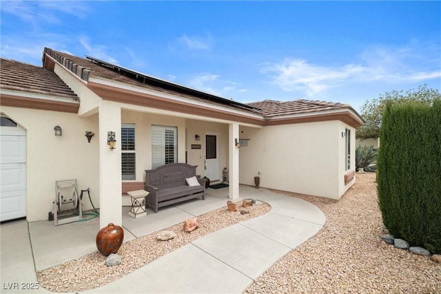 180 W Wilson Rd, Pahrump, NV 89048 - doorway to property with stucco siding and solar panels