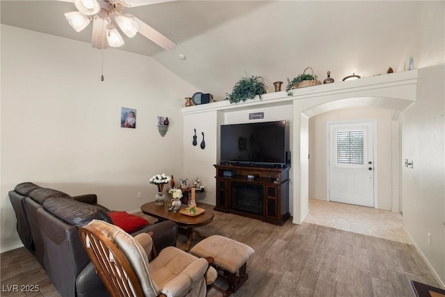 180 W Wilson Rd, Pahrump, NV 89048 - living room with wood finished floors, a ceiling fan, lofted ceiling, and arched walkways
