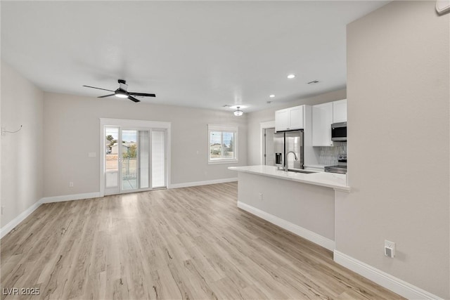 2120 Upland Ave, Pahrump, NV 89048 - unfurnished living room featuring ceiling fan, light wood finished floors, and recessed lighting