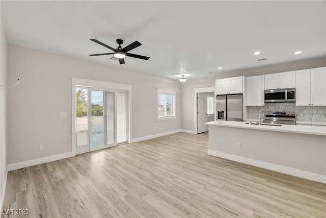 2120 Upland Ave, Pahrump, NV 89048 - kitchen with appliances with stainless steel finishes, open floor plan, light countertops, healthy amount of natural light, and recessed lighting