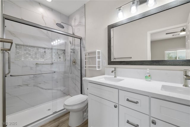 2120 Upland Ave, Pahrump, NV 89048 - bathroom featuring a marble finish shower, double vanity, and wood finished floors