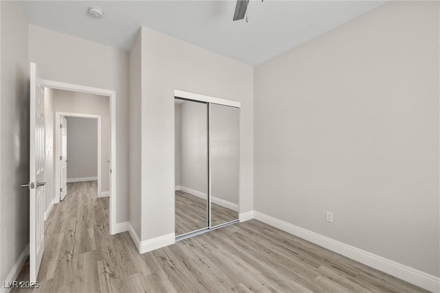 2120 Upland Ave, Pahrump, NV 89048 - unfurnished bedroom featuring wood finished floors, a closet, and a ceiling fan