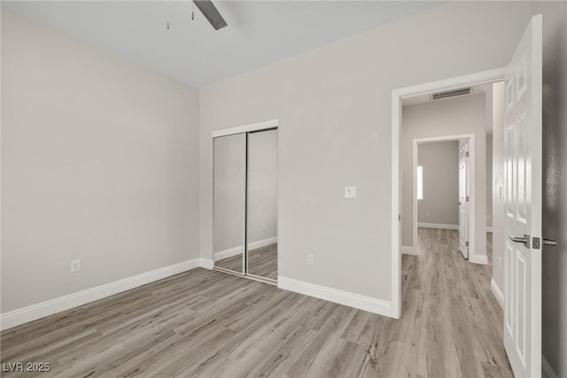2120 Upland Ave, Pahrump, NV 89048 - unfurnished bedroom featuring wood finished floors, a closet, and a ceiling fan