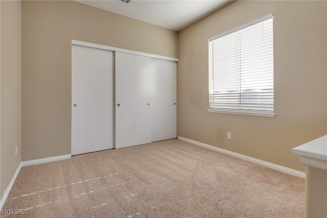2245 Juniper Berry Dr, Las Vegas, NV 89134 - unfurnished bedroom with carpet flooring, a closet, and multiple windows