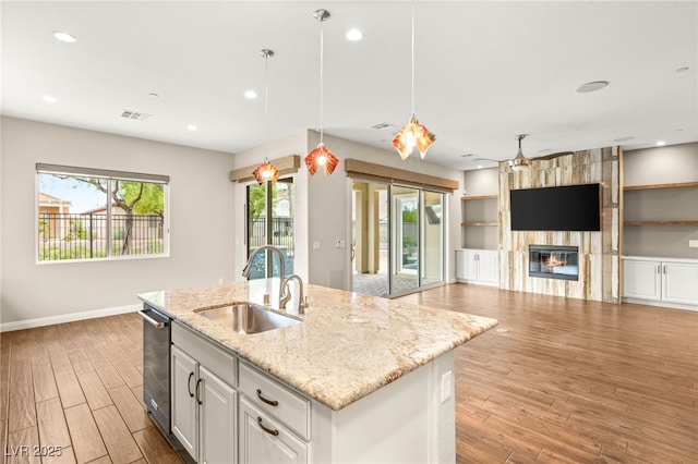2116 Canvas Edge Dr, Henderson, NV 89044 - kitchen featuring light wood-style flooring, open floor plan, a ceiling fan, light stone countertops, and recessed lighting