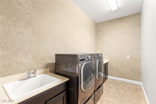 2116 Canvas Edge Dr, Henderson, NV 89044 - washroom featuring independent washer and dryer, cabinet space, a textured wall, and light tile patterned floors