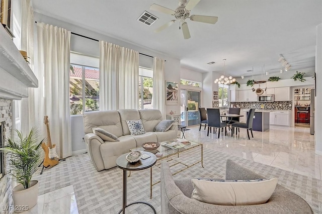 2021 Waterbury Ln, Las Vegas, NV 89134 - living area with a ceiling fan, a chandelier, and plenty of natural light
