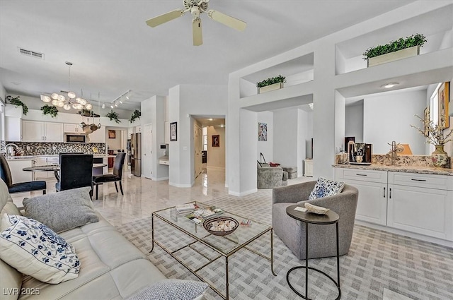 2021 Waterbury Ln, Las Vegas, NV 89134 - living area with a ceiling fan, track lighting, a towering ceiling, and a chandelier