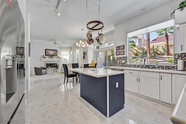 2021 Waterbury Ln, Las Vegas, NV 89134 - kitchen with a fireplace, open floor plan, tasteful backsplash, and healthy amount of natural light