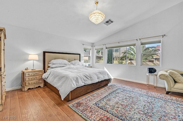 2021 Waterbury Ln, Las Vegas, NV 89134 - bedroom featuring lofted ceiling, light wood-style flooring, and a chandelier
