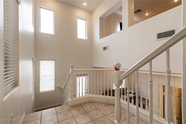 3412 Bearpin Gap Ln, Las Vegas, NV 89129 - staircase with tile patterned floors, a high ceiling, and recessed lighting