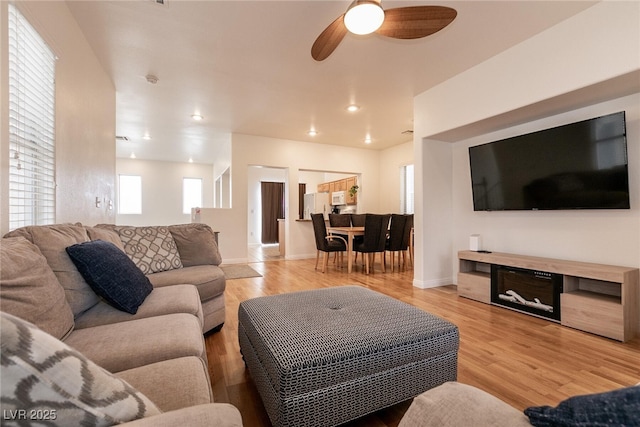 3412 Bearpin Gap Ln, Las Vegas, NV 89129 - living room with a ceiling fan and light wood-style flooring