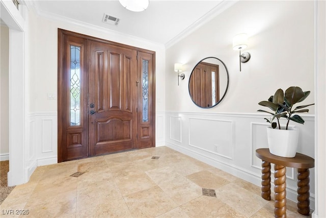 2477 Adobe Wells Dr, Logandale, NV 89021 - foyer entrance featuring a decorative wall, ornamental molding, and wainscoting
