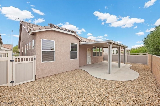 924 Crescent Falls St, Henderson, NV 89011 - rear view of house with a fenced backyard, a patio area, a tile roof, and stucco siding