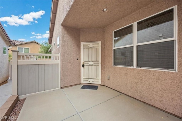 924 Crescent Falls St, Henderson, NV 89011 - view of exterior entry with stucco siding and a patio area