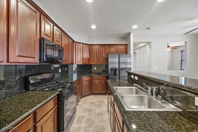 924 Crescent Falls St, Henderson, NV 89011 - kitchen with black appliances, tasteful backsplash, a ceiling fan, recessed lighting, and dark stone countertops