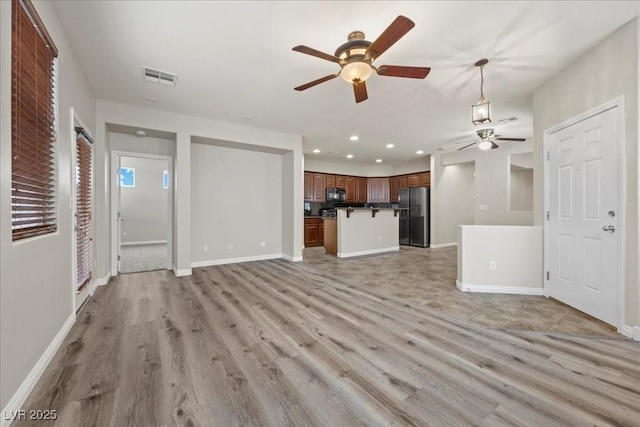 924 Crescent Falls St, Henderson, NV 89011 - unfurnished living room featuring ceiling fan, light wood finished floors, and recessed lighting