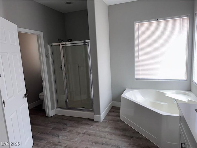 8993 Dorrell Ln, Las Vegas, NV 89149 - full bathroom featuring a shower stall, a bath, and wood finished floors