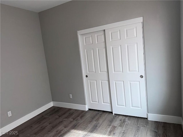 8993 Dorrell Ln, Las Vegas, NV 89149 - unfurnished bedroom with dark wood-style flooring and a closet