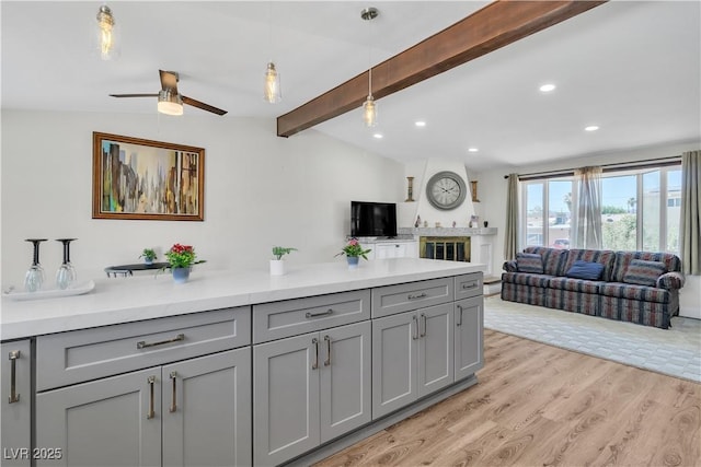 4654 Gabriel Dr, Las Vegas, NV 89121 - kitchen with gray cabinets, open floor plan, light wood finished floors, ceiling fan, and recessed lighting