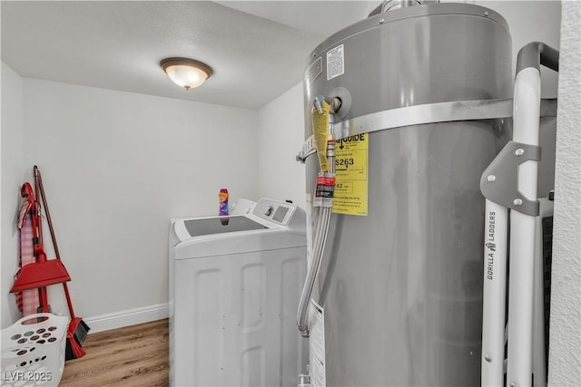 4654 Gabriel Dr, Las Vegas, NV 89121 - laundry room featuring washing machine and dryer, strapped water heater, and wood finished floors