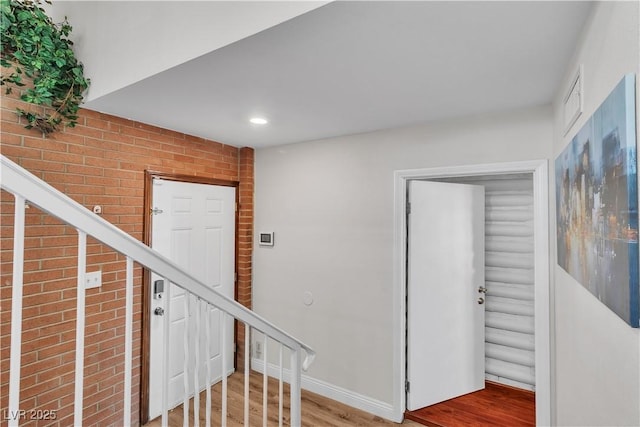 4654 Gabriel Dr, Las Vegas, NV 89121 - stairway with wood finished floors, brick wall, and recessed lighting
