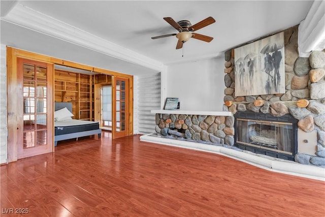 4654 Gabriel Dr, Las Vegas, NV 89121 - living area with a stone fireplace, french doors, wood finished floors, and a ceiling fan