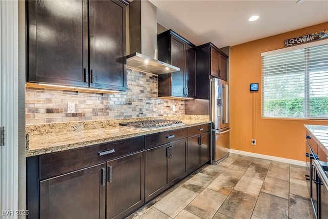 1860 Moonbow Falls St, Henderson, NV 89044 - kitchen with wall chimney range hood, stainless steel appliances, backsplash, light stone counters, and recessed lighting