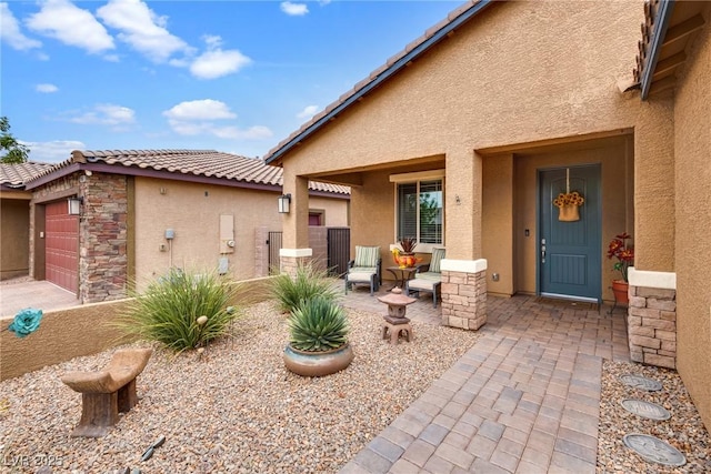 1860 Moonbow Falls St, Henderson, NV 89044 - entrance to property with stucco siding, a tile roof, stone siding, and a garage
