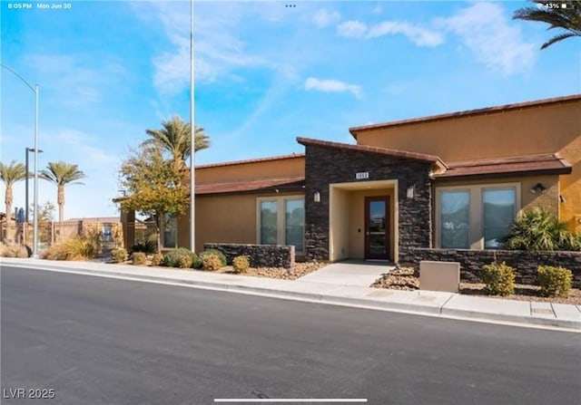 1860 Moonbow Falls St, Henderson, NV 89044 - view of front of home with stone siding and stucco siding