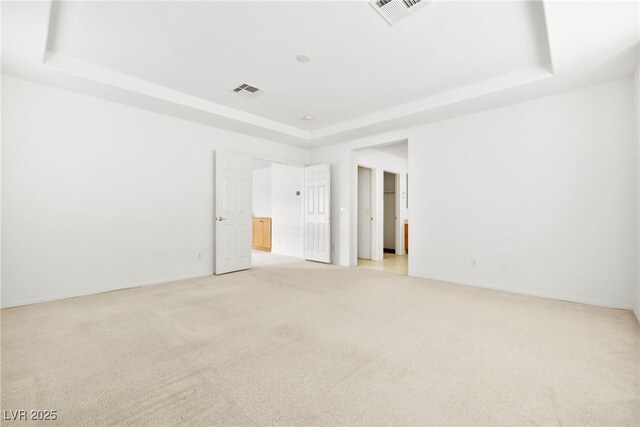 8065 Retriever Ave, Las Vegas, NV 89147 - unfurnished room featuring a raised ceiling and light carpet