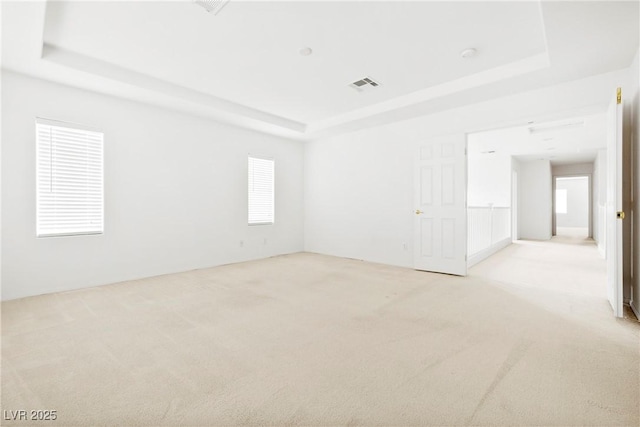 8065 Retriever Ave, Las Vegas, NV 89147 - spare room with a tray ceiling and light carpet