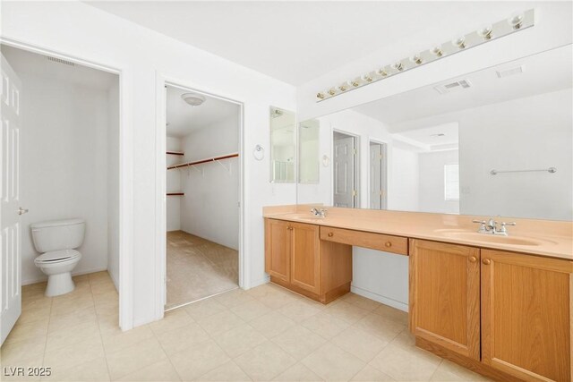 8065 Retriever Ave, Las Vegas, NV 89147 - bathroom featuring double vanity and a walk in closet