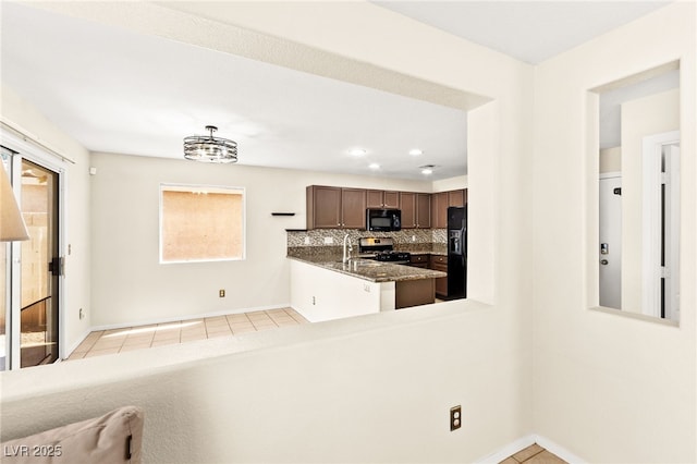 6044 Seneca Springs St, Las Vegas, NV 89130 - kitchen featuring black appliances, light tile patterned flooring, tasteful backsplash, recessed lighting, and dark stone counters