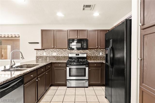 6044 Seneca Springs St, Las Vegas, NV 89130 - kitchen featuring black appliances, stone counters, backsplash, light tile patterned floors, and a peninsula