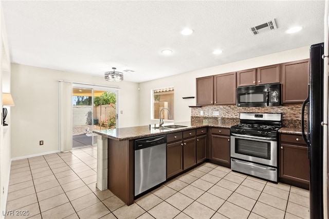 6044 Seneca Springs St, Las Vegas, NV 89130 - kitchen with black appliances, a peninsula, backsplash, light tile patterned flooring, and recessed lighting