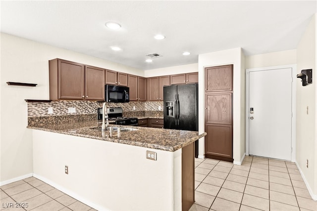 6044 Seneca Springs St, Las Vegas, NV 89130 - kitchen featuring black appliances, a peninsula, light tile patterned flooring, backsplash, and recessed lighting